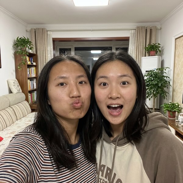Two friends taking a selfie together at home